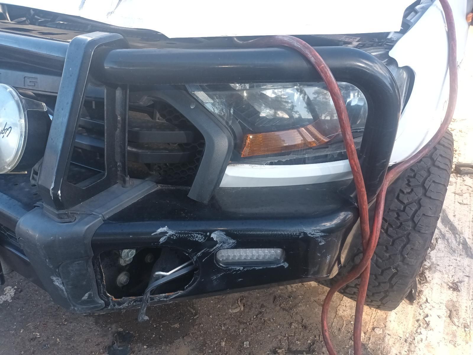 A White Truck with a Black Bumper and a Red Hose Attached to It — South West 4WD Wreckers in Harristown, QLD