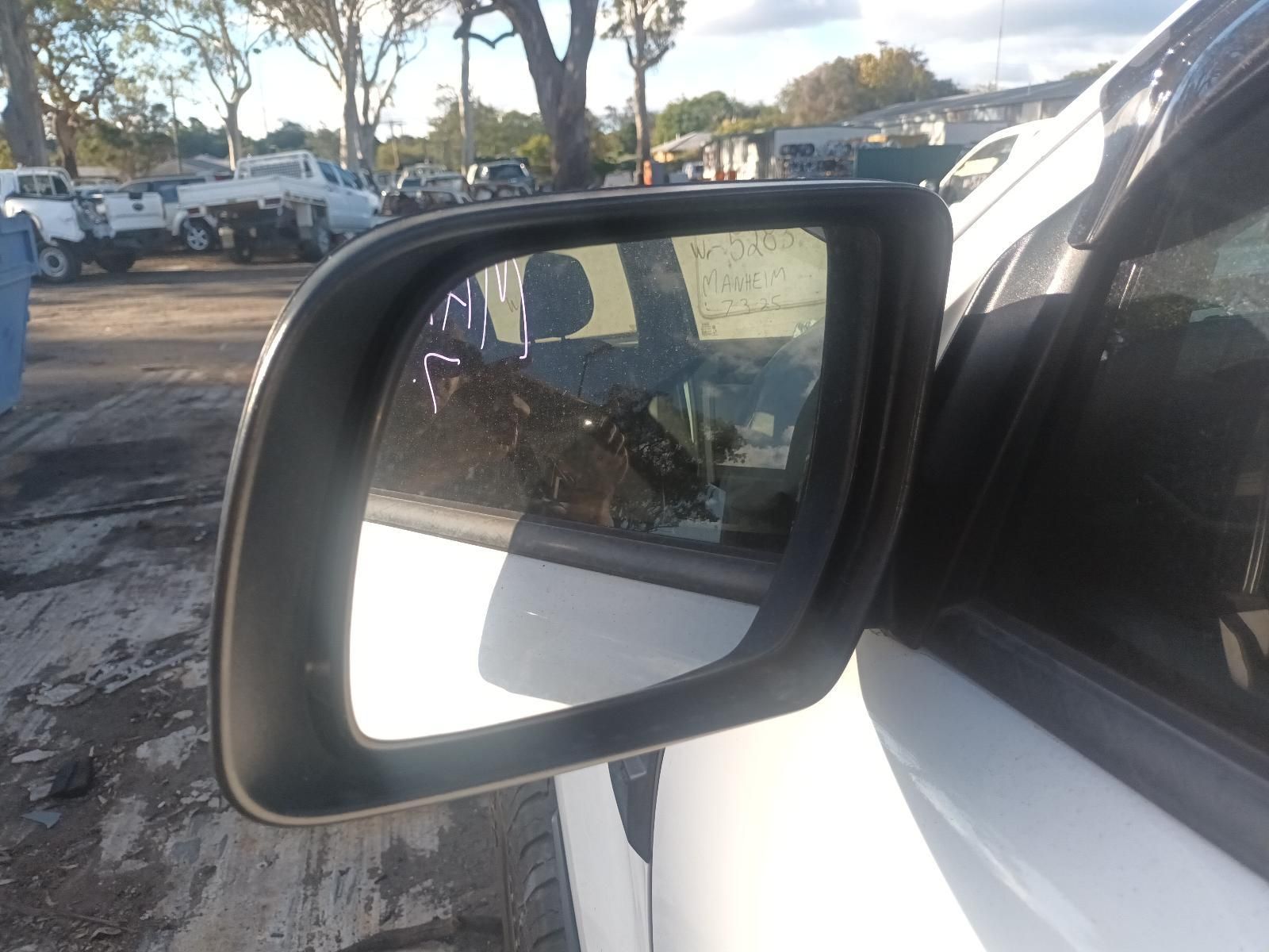 A Close Up of a Side View Mirror on a White Car — South West 4WD Wreckers in Harristown, QLD