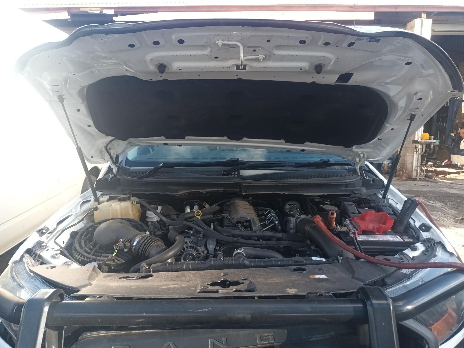 The Hood of a White Truck is Open and the Engine is Visible — South West 4WD Wreckers in Harristown, QLD