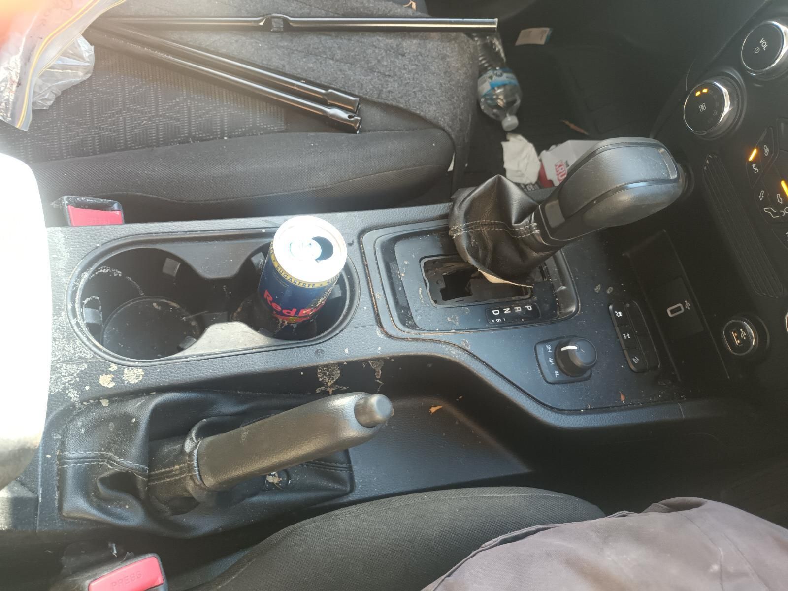 A Dirty Car Console with a Can of Soda in It — South West 4WD Wreckers in Harristown, QLD