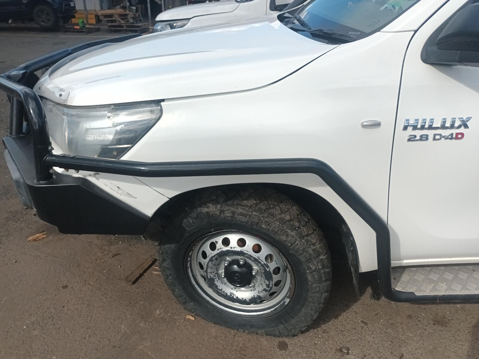A White Hilux Truck is Parked in a Parking Lot — South West 4WD Wreckers in Harristown, QLD