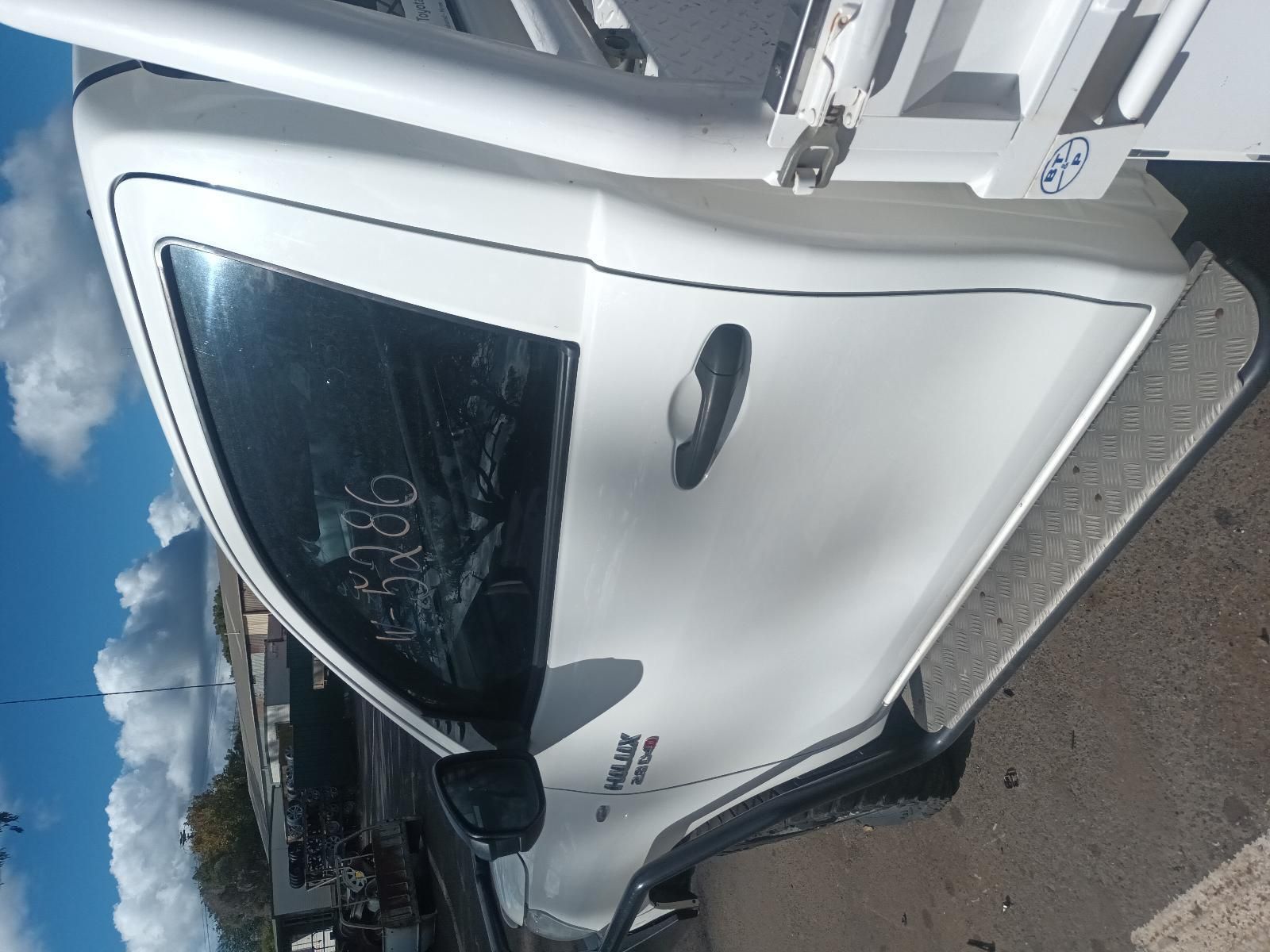 A White Car is Parked on the Side of the Road — South West 4WD Wreckers in Harristown, QLD