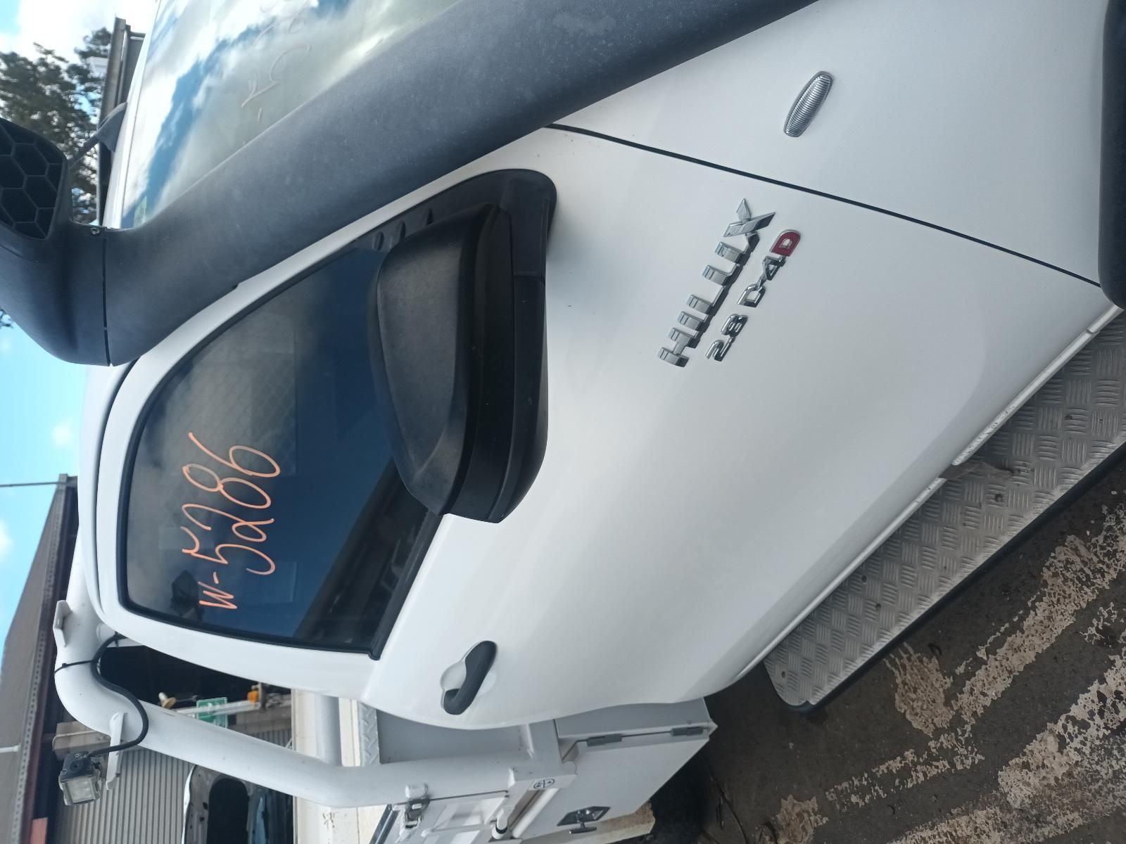 A White Hilux Truck is Parked on the Side of the Road — South West 4WD Wreckers in Harristown, QLD