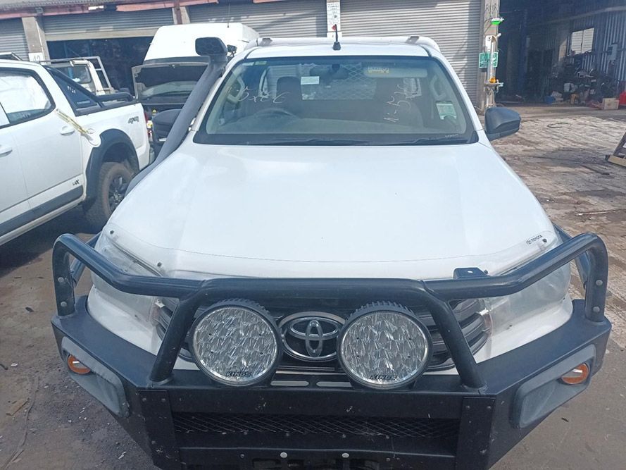 A White Truck with a Black Bumper is Parked in a Parking Lot — South West 4WD Wreckers in Harristown, QLD