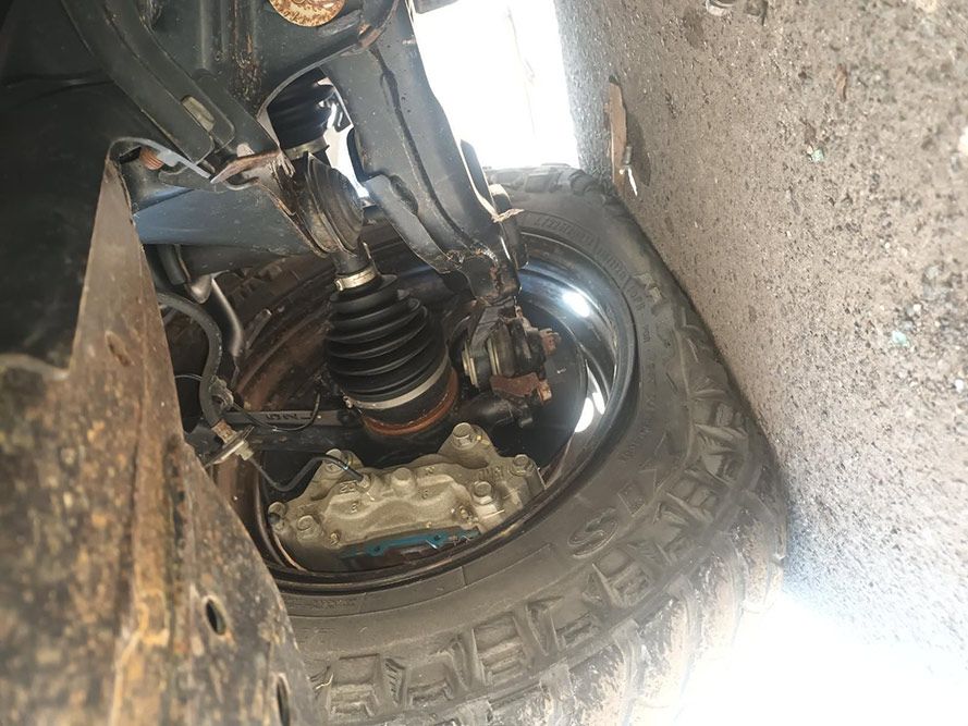 A Close Up of the Underside of a Car with a Tire — South West 4WD Wreckers in Harristown, QLD