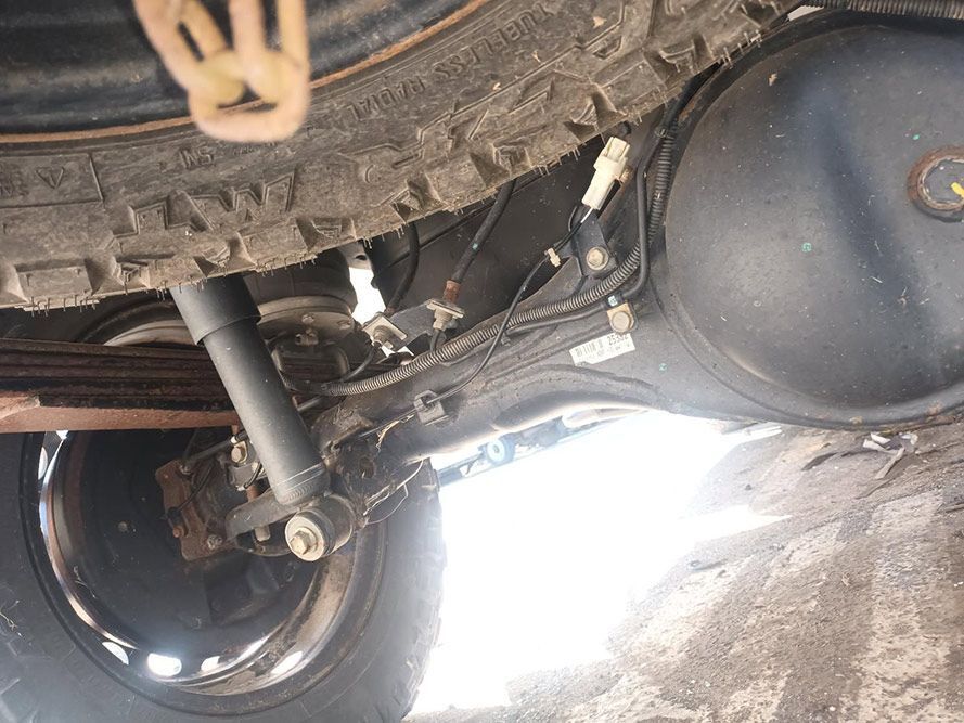 A Close Up of the Underside of a Car with a Tire and Shock Absorber — South West 4WD Wreckers in Harristown, QLD