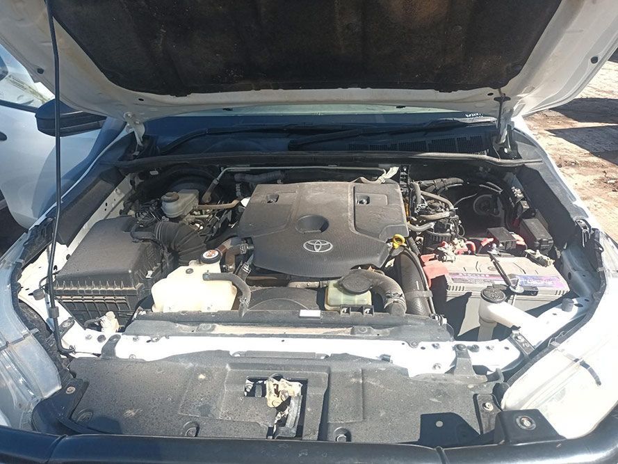 The Engine of a White Car is Shown with the Hood Up — South West 4WD Wreckers in Harristown, QLD 