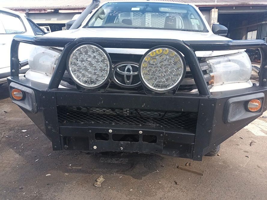 A White Toyota Hilux with a Black Bumper is Parked in a Parking Lot — South West 4WD Wreckers in Harristown, QLD