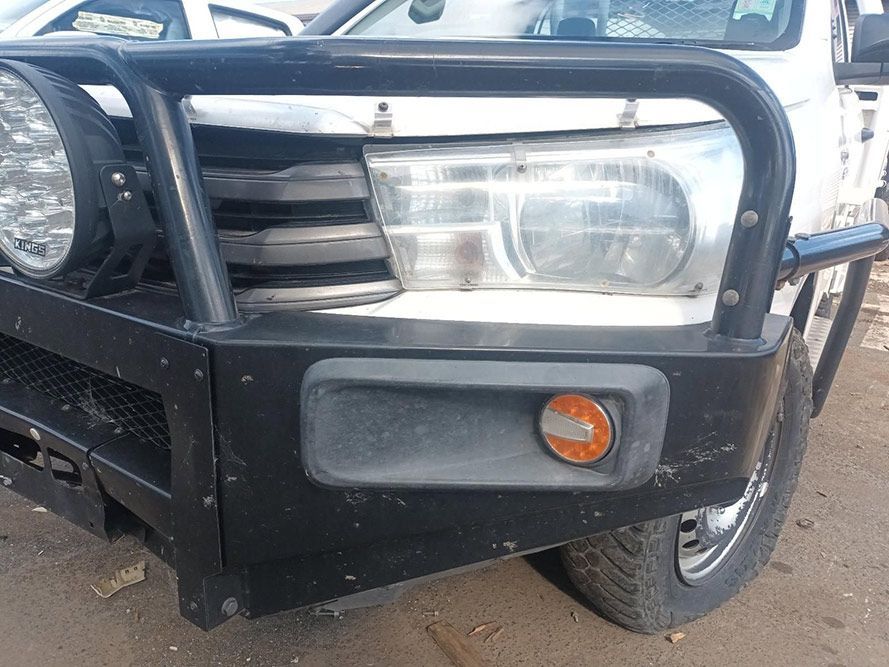 A White Truck with a Black Bumper is Parked on a Dirt Road — South West 4WD Wreckers in Harristown, QLD