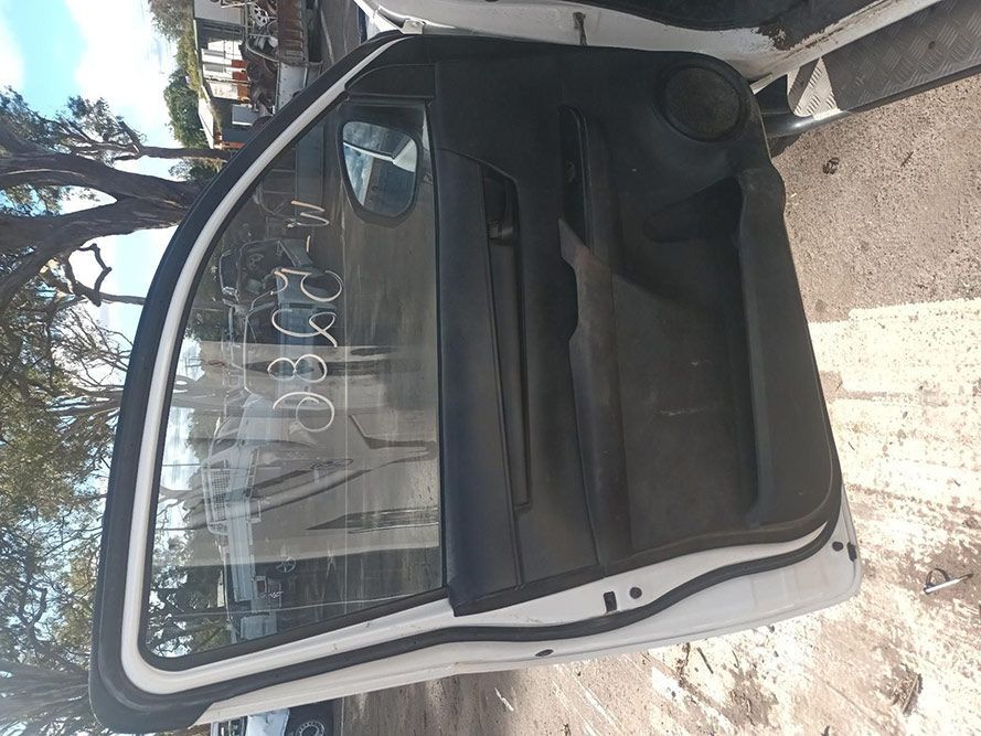 A White Car with the Door Open is Parked on the Side of the Road — South West 4WD Wreckers in Harristown, QLD