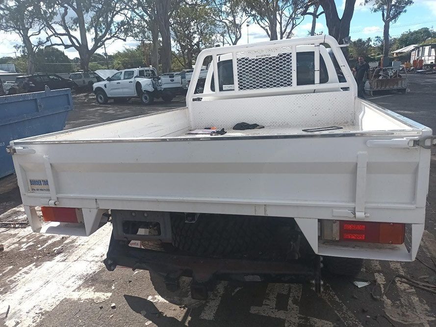 A White Truck is Parked in a Parking Lot — South West 4WD Wreckers in Harristown, QLD