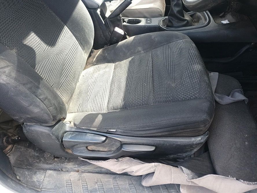 A Dirty Car Seat is Sitting in the Back Seat of a Car — South West 4WD Wreckers in Harristown, QLD