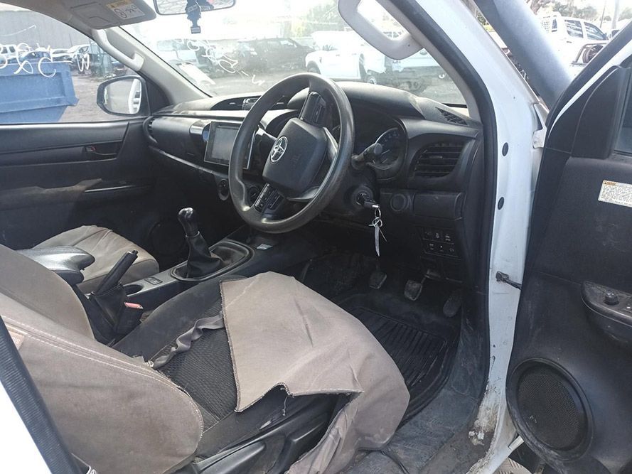 The Inside of a White Car with a Steering Wheel and Seats — South West 4WD Wreckers in Harristown, QLD