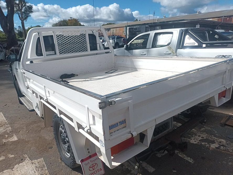 A White Toyota Truck is Parked in a Parking Lot — South West 4WD Wreckers in Harristown, QLD