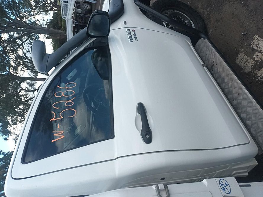 A White Truck is Parked on the Side of the Road — South West 4WD Wreckers in Harristown, QLD