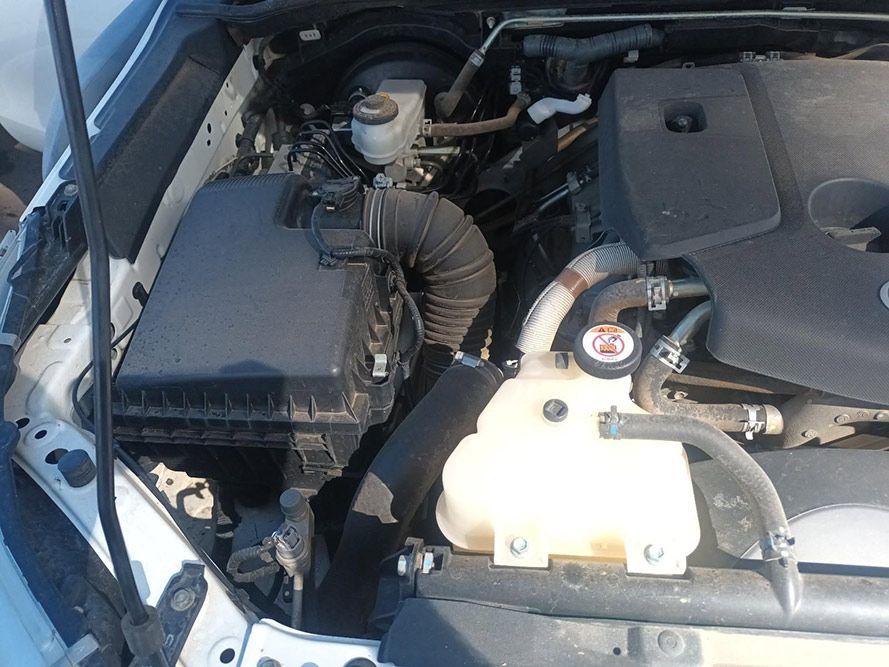 The Engine of a White Car is Shown with the Hood Open — South West 4WD Wreckers in Harristown, QLD