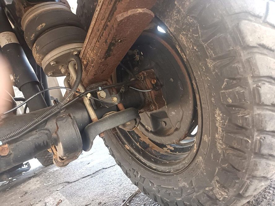A Close Up of the Rear End of a Truck with a Large Tire — South West 4WD Wreckers in Harristown, QLD