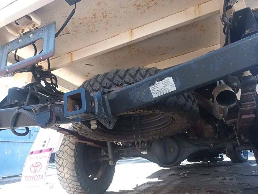 The Underside of a Toyota Truck with a Trailer Attached to It — South West 4WD Wreckers in Harristown, QLD