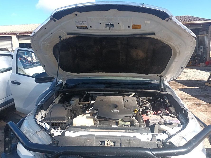 The Hood of a White Truck is Open and the Engine is Visible — South West 4WD Wreckers in Harristown, QLD