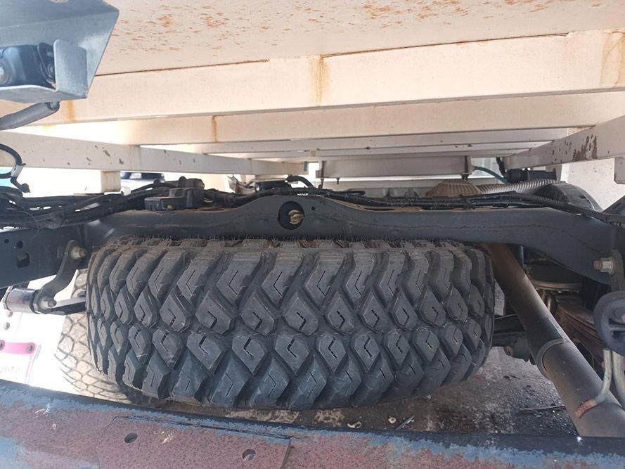 A Large Tire is on the Back of a Truck — South West 4WD Wreckers in Harristown, QLD