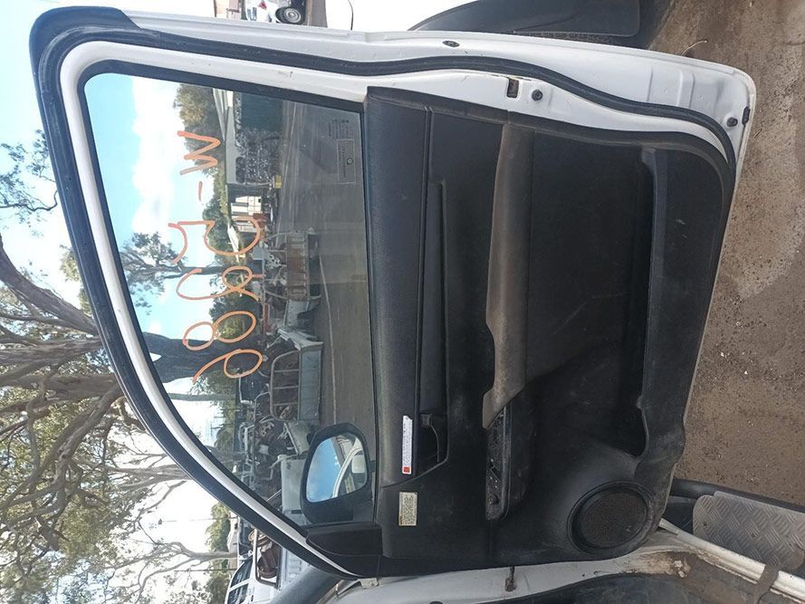 A White Car with the Door Open is Parked in a Parking Lot — South West 4WD Wreckers in Harristown, QLD