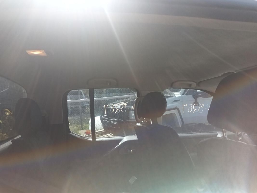 A Person is Sitting in the Back Seat of a Car Looking Out the Window — South West 4WD Wreckers in Harristown, QLD