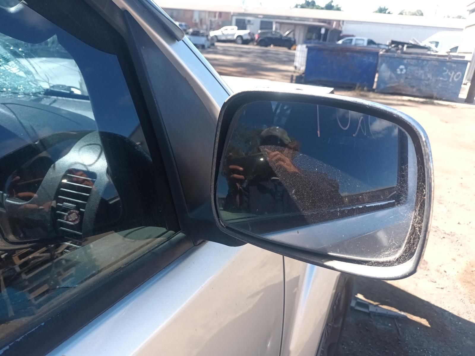 A Man is Taking a Picture of Himself in the Side Mirror of a Car — South West 4WD Wreckers in Harristown, QLD