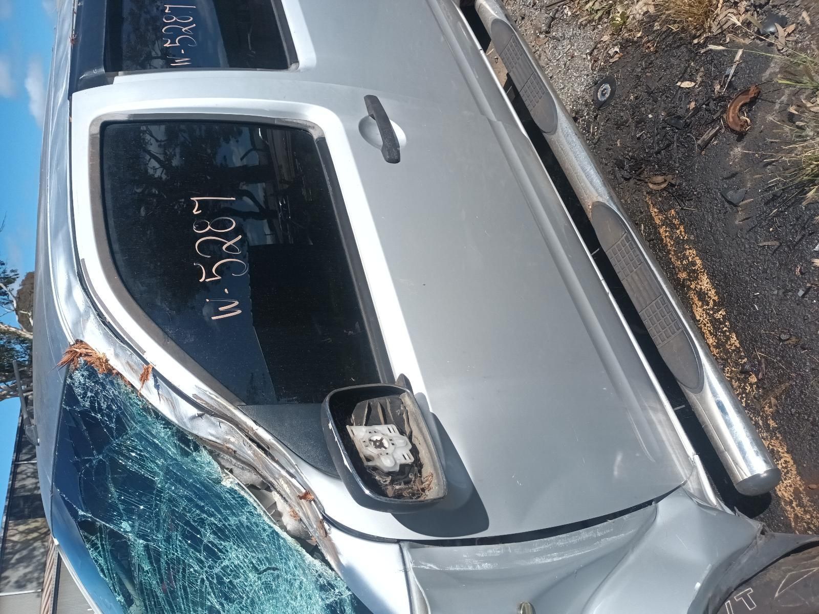 A Silver Truck with a Broken Windshield is Parked on the Side of the Road — South West 4WD Wreckers in Harristown, QLD