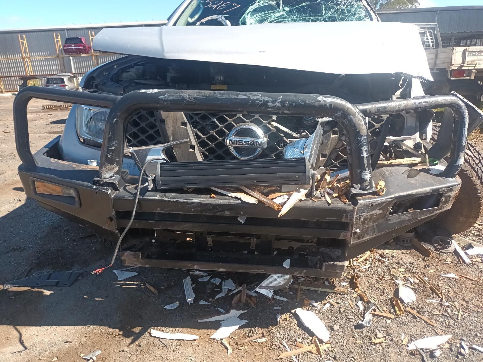 A Nissan Truck with a Broken Bumper is Sitting on the Ground — South West 4WD Wreckers in Harristown, QLD