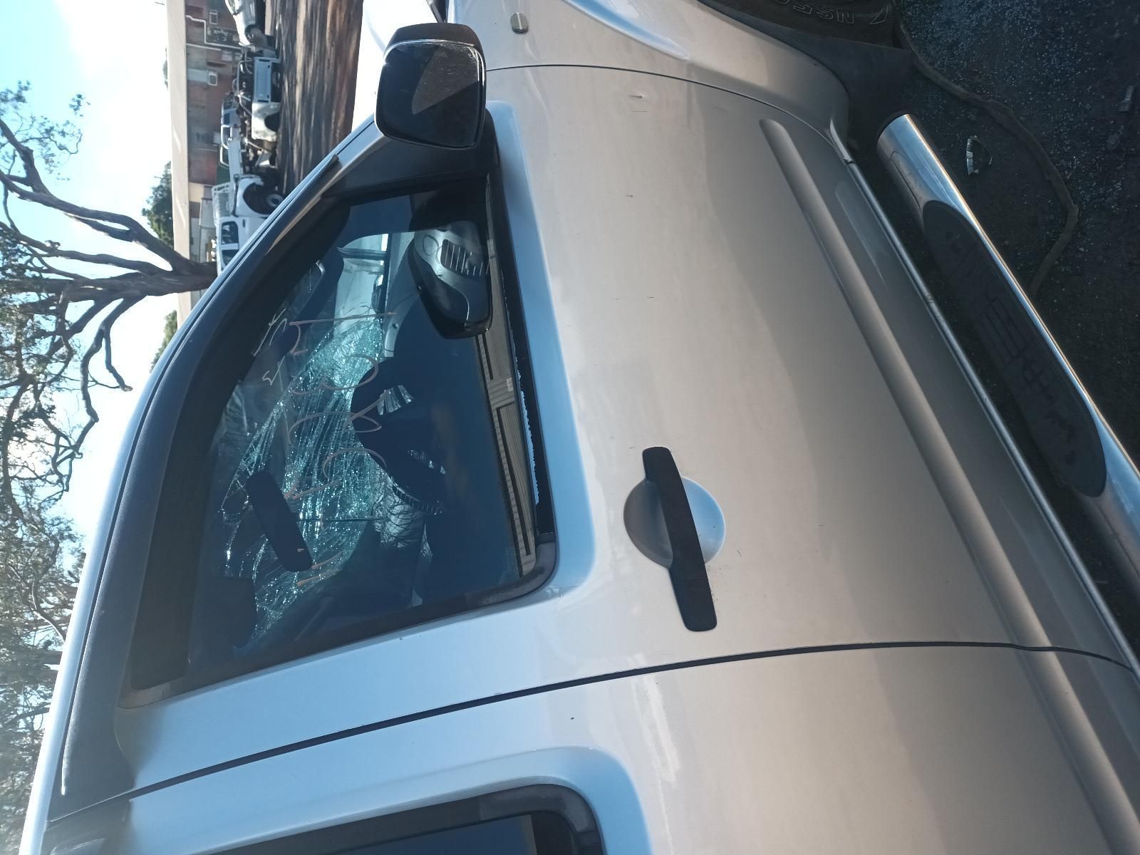 A Silver Truck with a Broken Windshield is Parked on the Side of the Road — South West 4WD Wreckers in Harristown, QLD