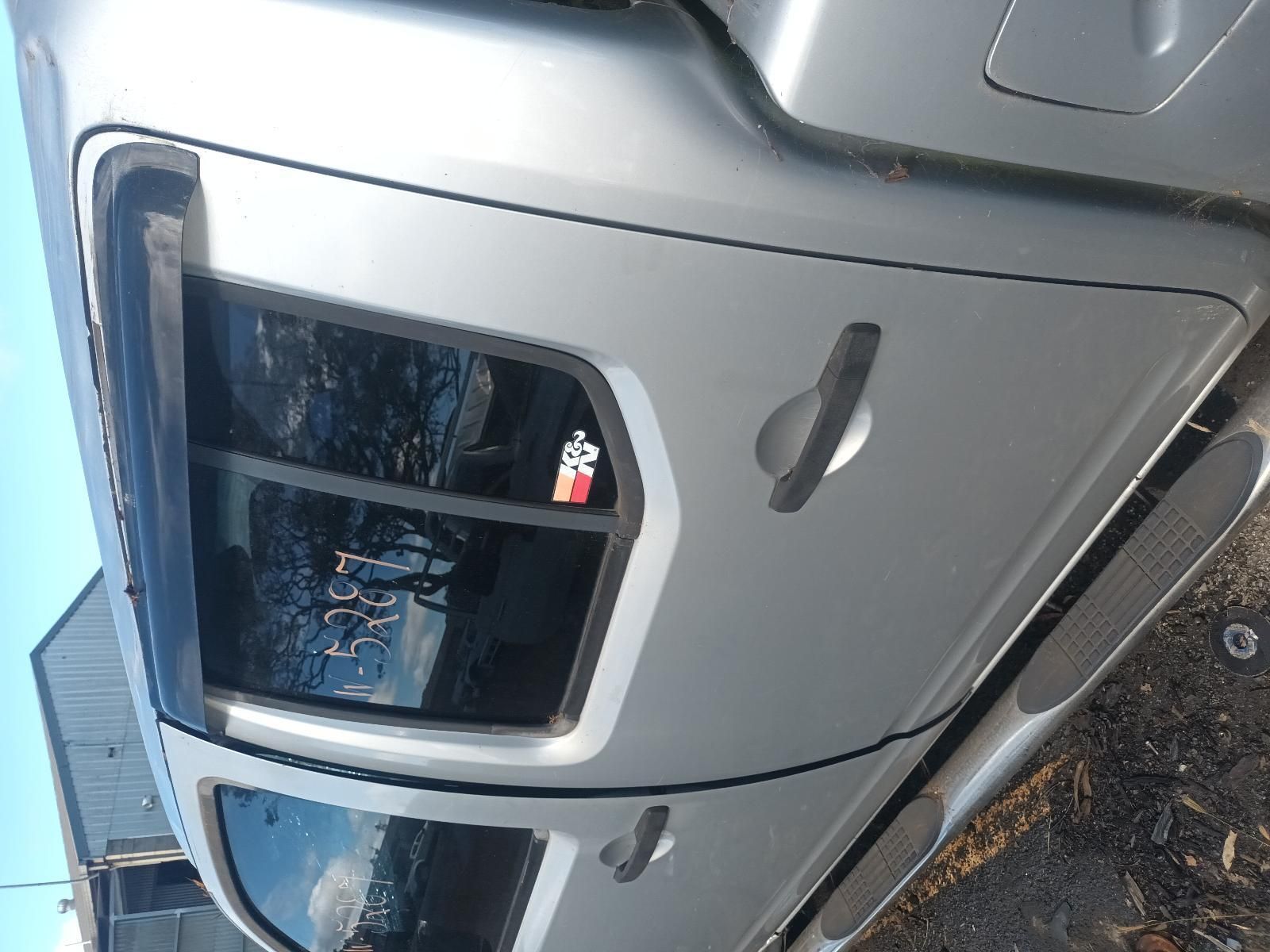 A Silver Truck is Parked on the Side of the Road — South West 4WD Wreckers in Harristown, QLD