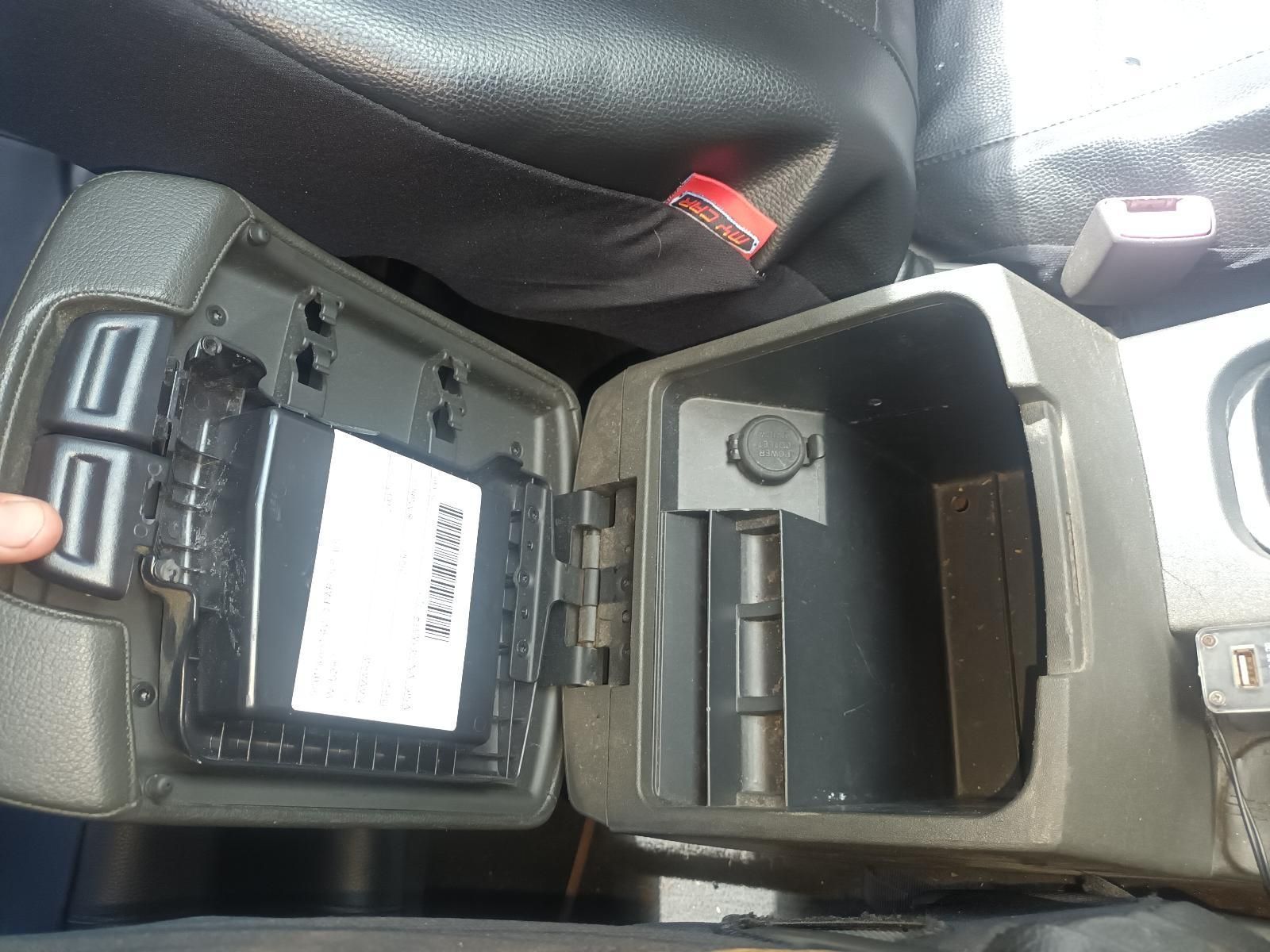 A Person is Opening a Car Console with a Card in It — South West 4WD Wreckers in Harristown, QLD