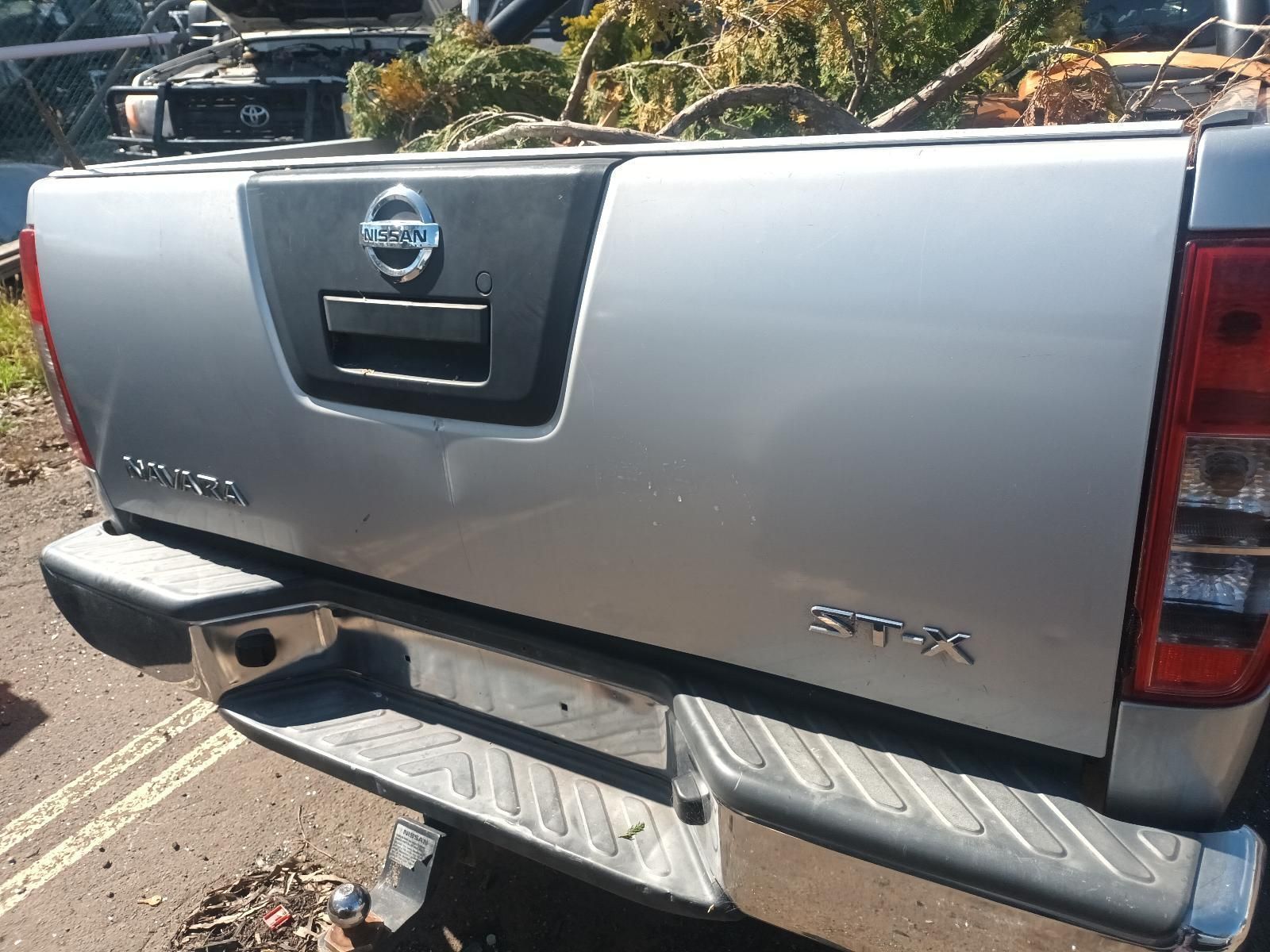 A Silver Nissan Pickup Truck is Parked on the Side of the Road — South West 4WD Wreckers in Harristown, QLD