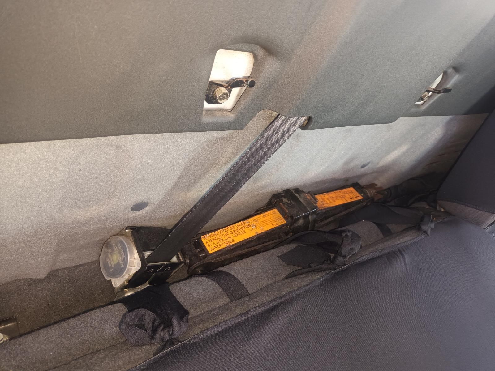 A Jack and a Flashlight Are Attached to the Back Seat of a Car — South West 4WD Wreckers in Harristown, QLD