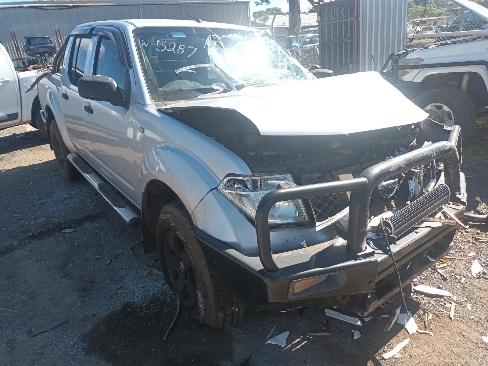 A White Truck with a Black Bumper is Parked in a Lot — South West 4WD Wreckers in Harristown, QLD