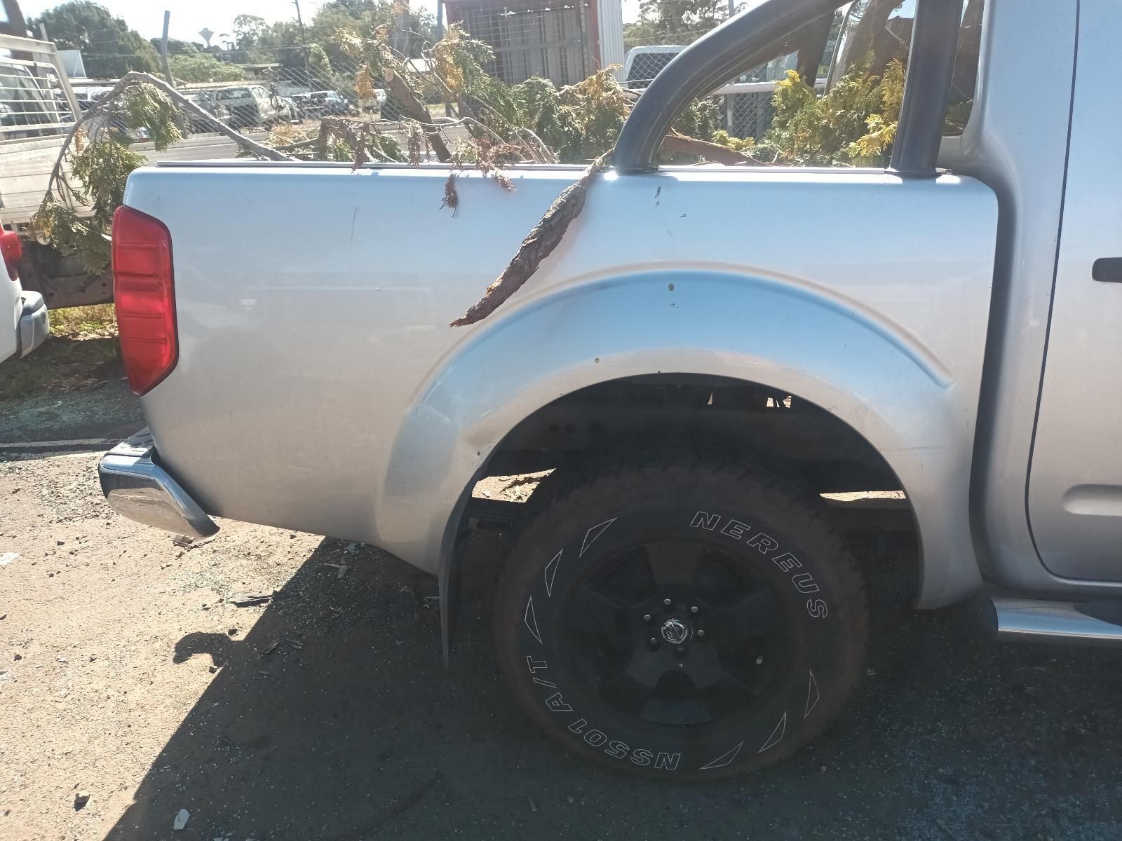 A Silver Truck with a Black Tire is Parked on the Side of the Road — South West 4WD Wreckers in Harristown, QLD