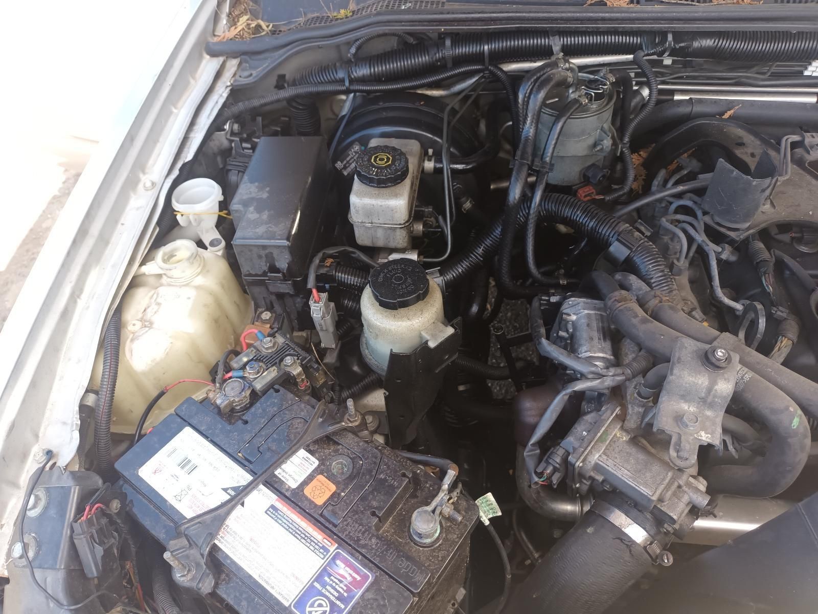 A Close Up of the Engine of a Car with a Battery — South West 4WD Wreckers in Harristown, QLD