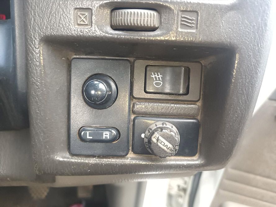 A Close Up of a Car Dashboard with a Light Switch and a Mirror Switch — South West 4WD Wreckers in Harristown, QLD