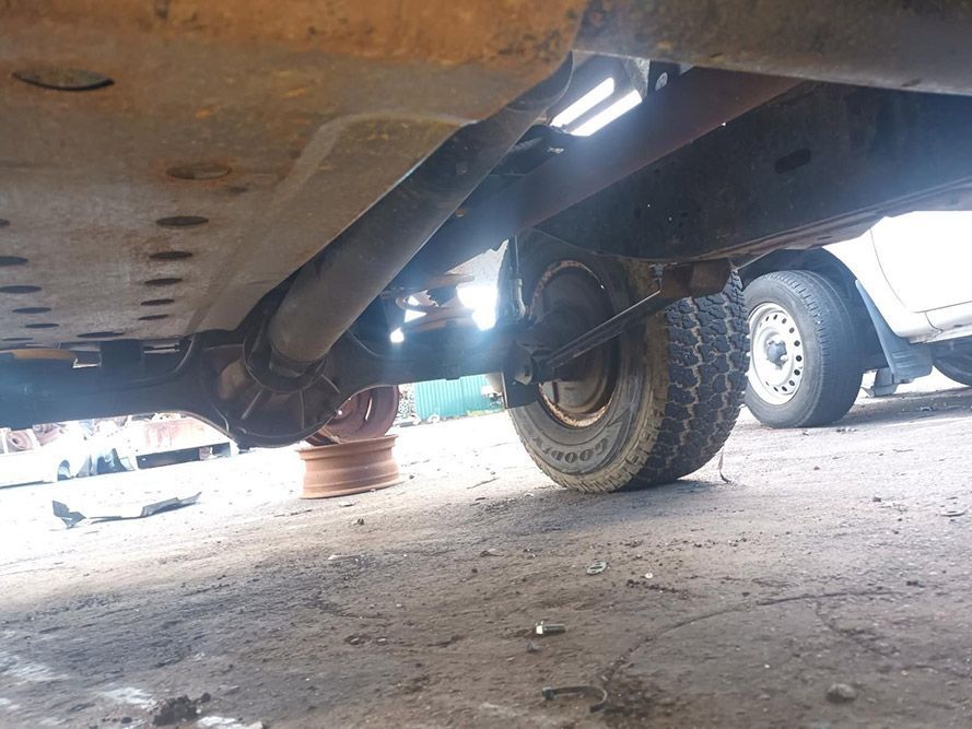 The Underside of a Truck is Shown in a Parking Lot — South West 4WD Wreckers in Harristown, QLD