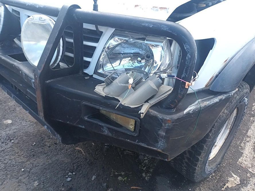 A White Truck with a Broken Bumper and Headlight — South West 4WD Wreckers in Harristown, QLD