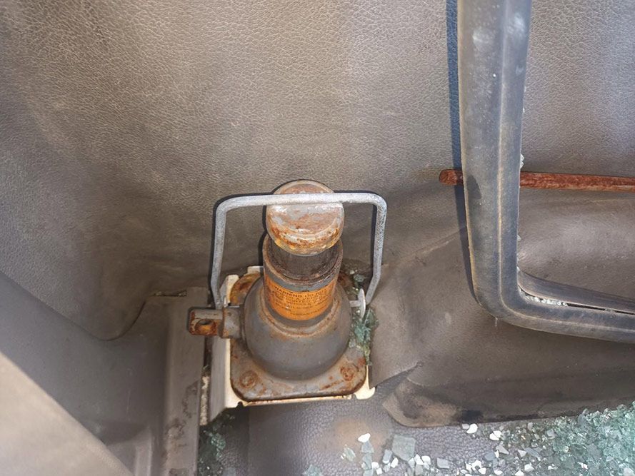 A Rusty Jack is Attached to the Back of a Car — South West 4WD Wreckers in Harristown, QLD