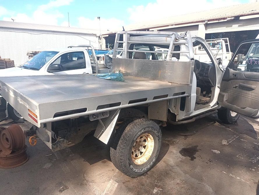 A Truck with a Flat Bed is Parked in a Parking Lot — South West 4WD Wreckers in Harristown, QLD