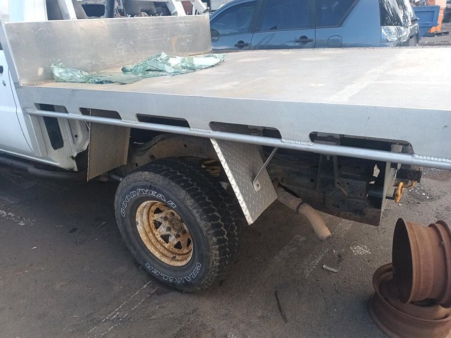 A Truck with a Flat Bed is Parked on the Side of the Road — South West 4WD Wreckers in Harristown, QLD