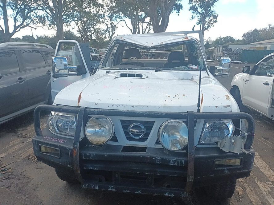 A White Nissan Truck with a Broken Windshield is Parked in a Parking Lot — South West 4WD Wreckers in Harristown, QLD