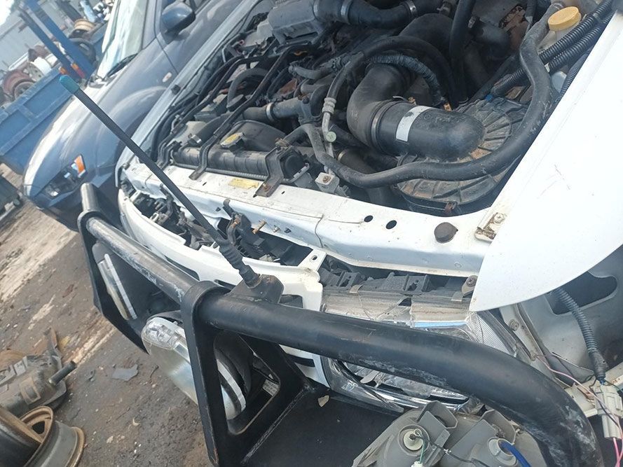 The Hood of a White Car is Open and the Engine is Visible — South West 4WD Wreckers in Harristown, QLD