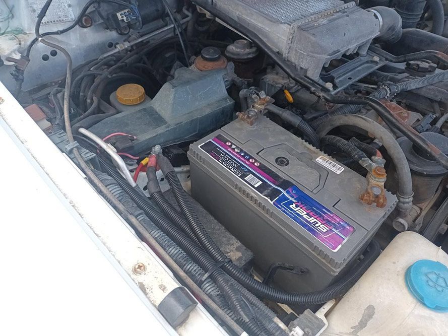 A Battery is Sitting Under the Hood of a Car — South West 4WD Wreckers in Harristown, QLD