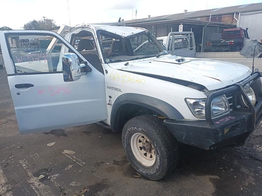 A White Truck with Its Doors Open is Parked in a Parking Lot — South West 4WD Wreckers in Harristown, QLD