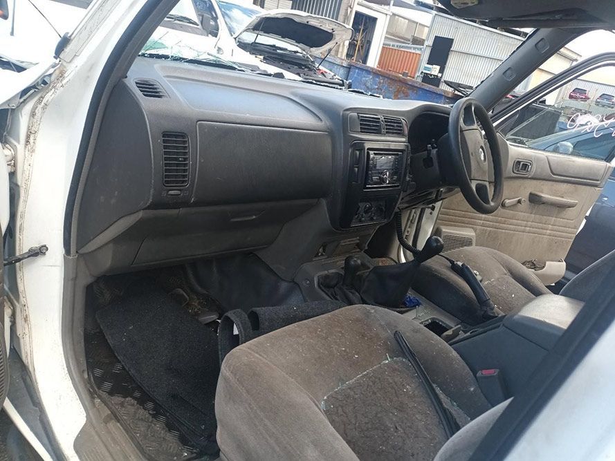 The Interior of a White Car with a Steering Wheel and Dashboard — South West 4WD Wreckers in Harristown, QLD