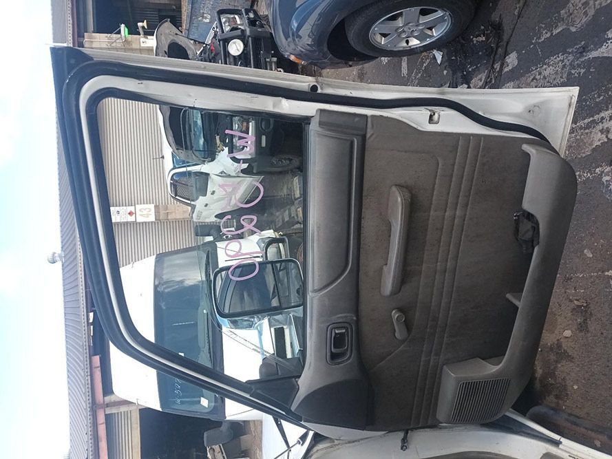 A White Car with the Door Open is Parked in a Garage — South West 4WD Wreckers in Harristown, QLD