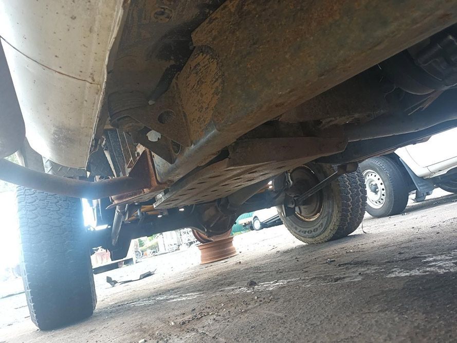 The Underside of a Truck is Shown in a Parking Lot — South West 4WD Wreckers in Harristown, QLD
